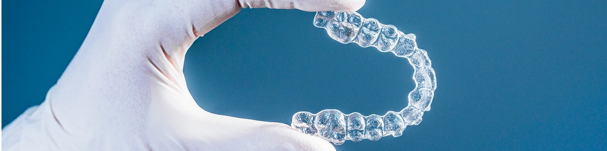 doctor-hand-holding-a-clear-dental-aligner-2025-02-12-22-58-59-utc-1 doctor hand holding a clear dental aligner 2025 02 12 22 58 59 utc 1